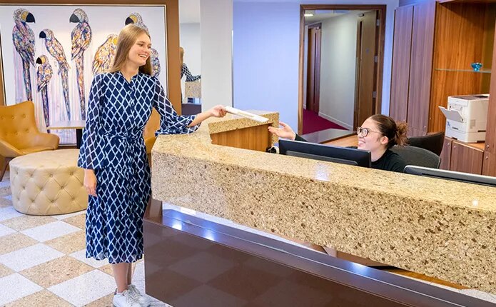 Servcorp receptionist handing mail for client at Mayfair.