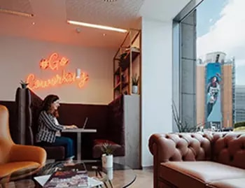 Servcorp Bastion Tower lounge with cozy booths, city views, and vibrant decor—perfect for productive work in a stylish setting.
