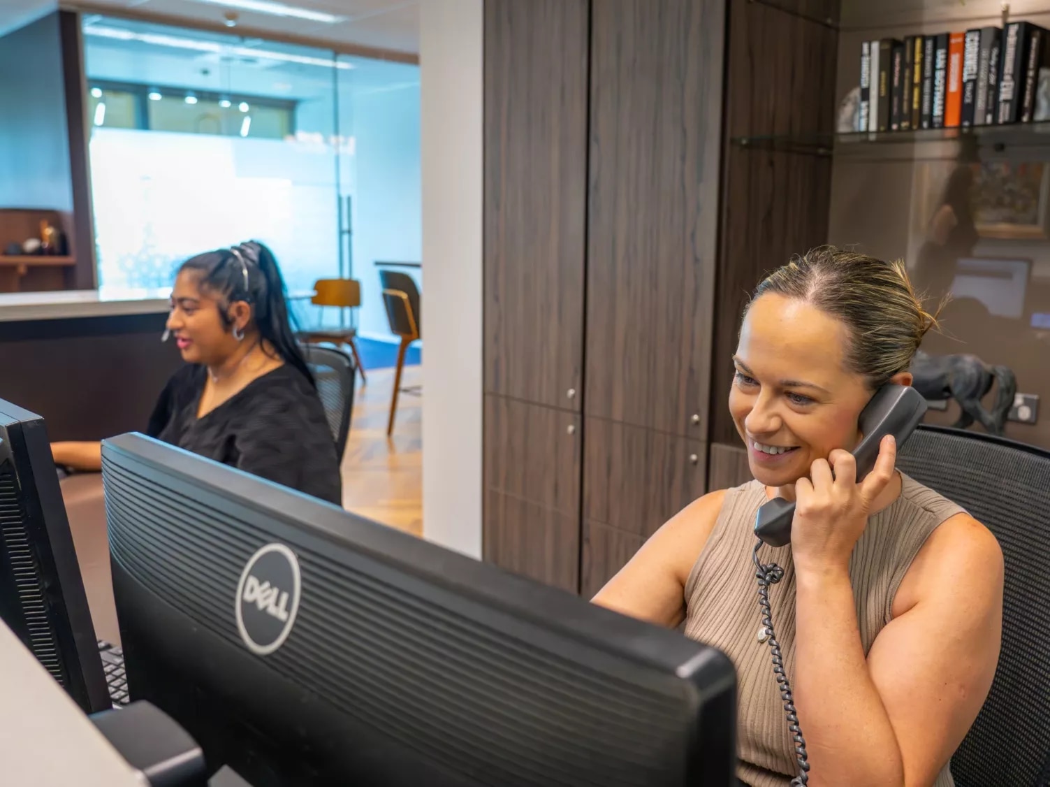 A dedicated receptionist on the phone with a client in Servcorp Santos Place, Brisbane